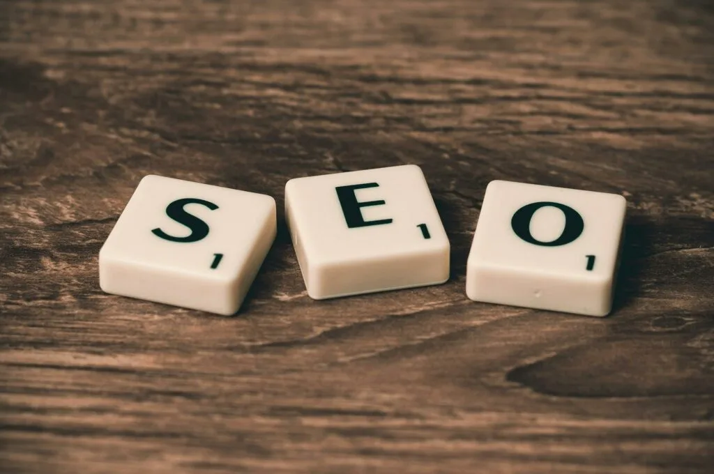 Scrabble tiles spelling SEO rest gracefully on a wooden surface, much like the precision in Melbourne Web Design.