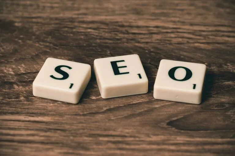 Scrabble tiles spelling SEO rest gracefully on a wooden surface, much like the precision in Melbourne Web Design.